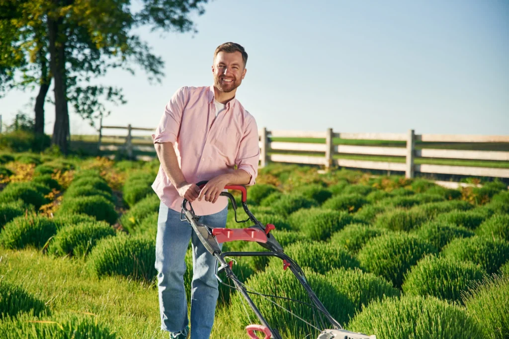 Man mowing lawn in the Gainesville summer heat